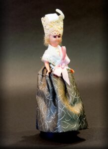 This doll was more than just a toy—it was used to smuggle secret photographs to Nazi Germany using a technique called microphotography. (Click image to view high-res.)